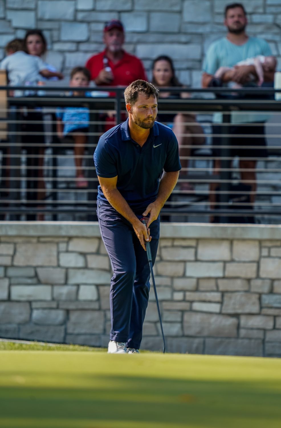 Zander watching a putt with spectators behind the green