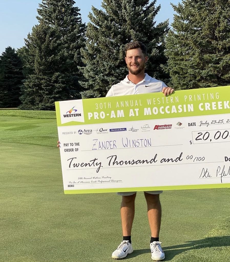 Zander holding the $20,000 Western Printing Pro-Am at Moccasin Creek check